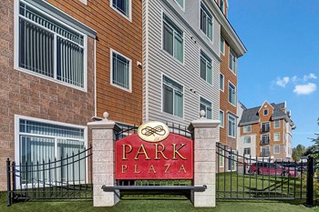 The sign at the entrance to the property with a sign reading Park Plaza Property Image